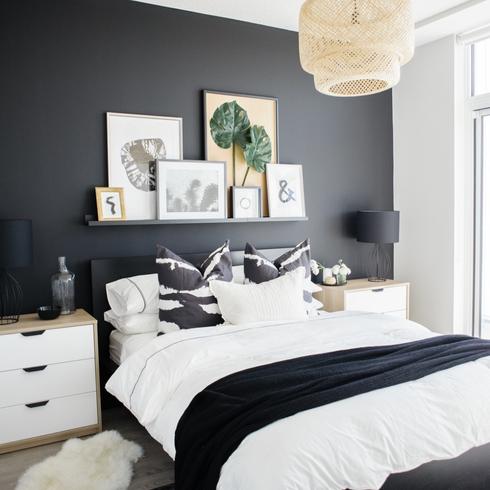 Hotel at Home Chic and curated black and white bedroom designed by Natalie Chong of Nest Design Studios featuring a matte black statement wall to frame the bed and side tables