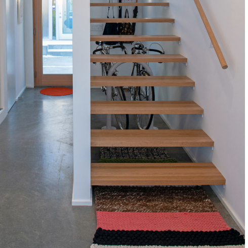 An Entrance That Sets the Tone A shot of a modern open wooden staircase and entryway