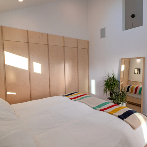 Waking in Tandem With Nature A shot of the bed and a built-in wardrobe