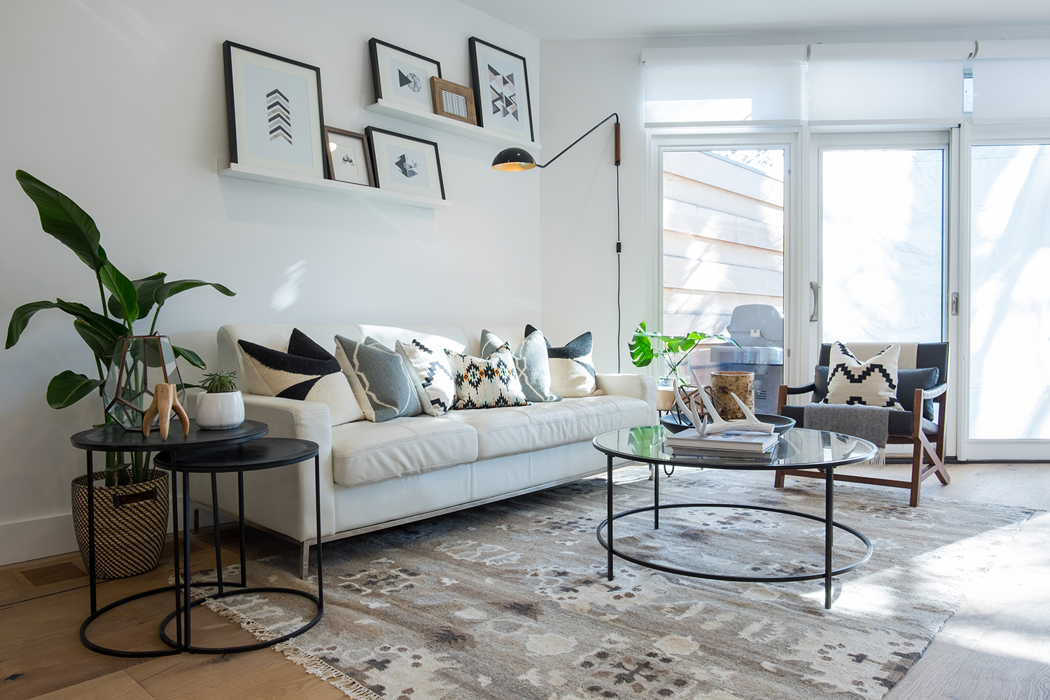 Angle Shot living room with three glass patio doors on angled wall