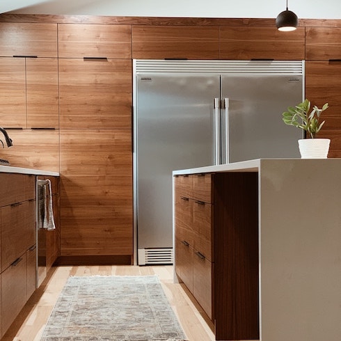 Space to Park Small Appliances A sleek kitchen with a wall of wooden cabinets and a large kitchen island