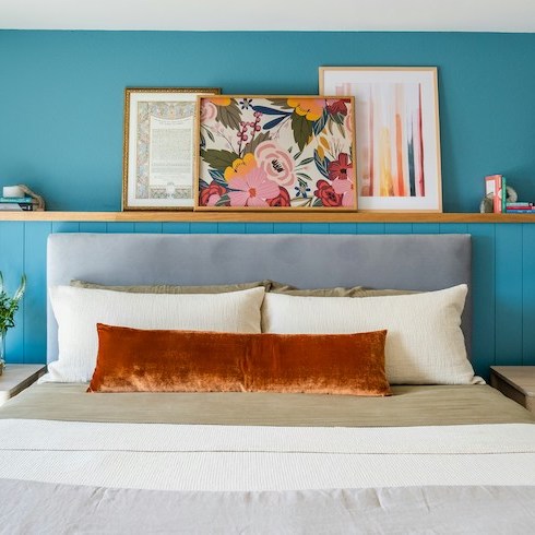 Blue Moods A bright blue bedroom with a white bed and pictures on the wall