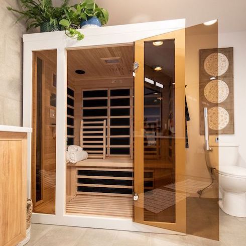 Wellness at Home A wood-framed infrared sauna in a spa-like bathroom