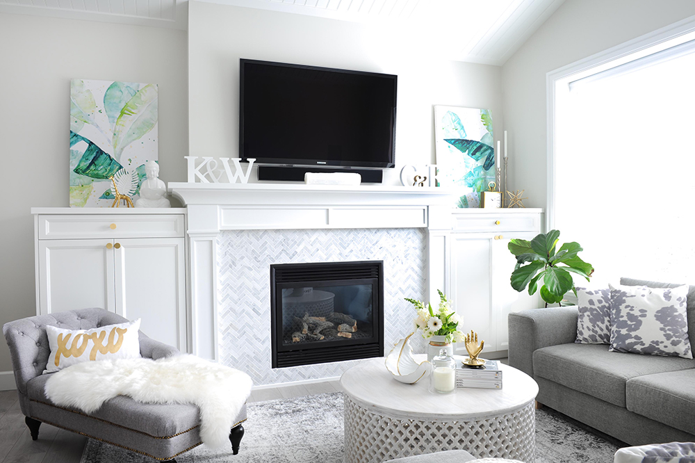 Built-in Beauty Coastal glam living room with herringbone tile fireplace surround.