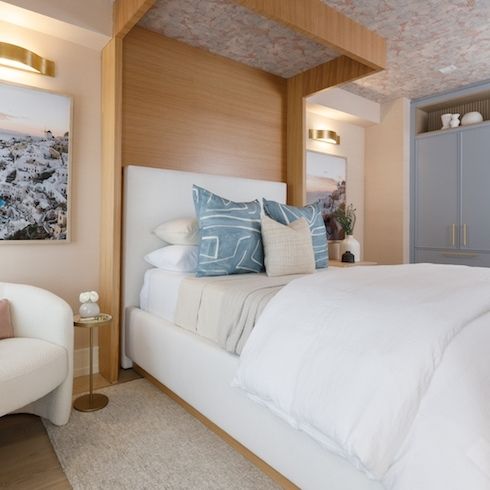 Let the Comfort In Wooden accent wall with a white bed and blue and tan pillows