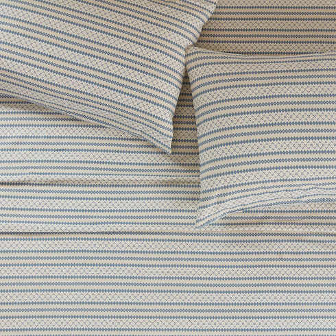 Nordic Nights Woolrich Flannel Sheet Set made with 100 per cent cotton featuring a Nordic themed geometric pattern of creams, whites and blue on a made bed with two pillows