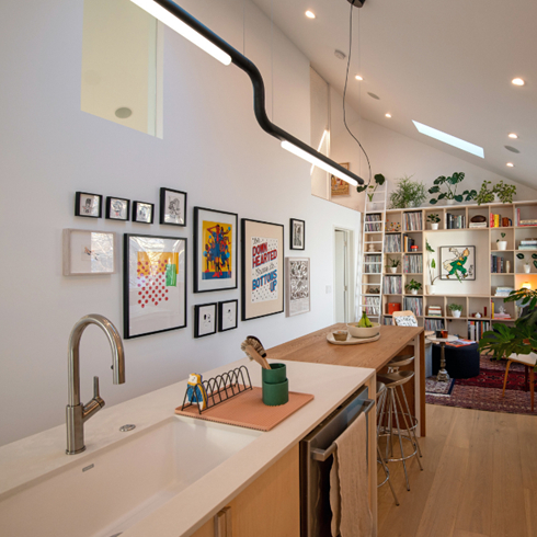 A Blank Canvas A modern open-concept kitchen with a white island and sink