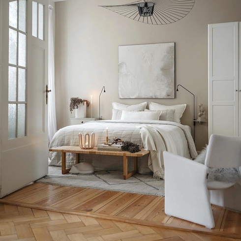 Hot Stone Message Light and airy neutral bedroom featuring Oxfordshire, England, Farrow & Ball's new Oxford Stone No. 264, wood floors and a cream coloured bed and chair