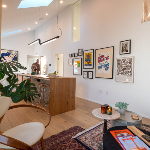 High Ceilings and Windows Abound A shot of a hallway with framed prints
