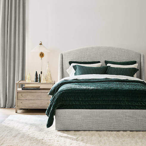 Spruce It Up Crate & Barrel Organic Cotton Flannel Spruce Green Windowpane Duvet Cover on an upholstered grey bed in a chic bedroom with white walls, tall grey drapes, wood floors with a plush cream coloured rug, a grey wood bedside table with decorate mercury glass trees and a wall scone