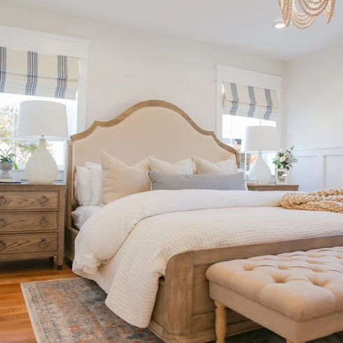 Alright With White Beautiful white bedroom with wooden bed and side dressers, white painted walls, and white and blue striped roman blinds.