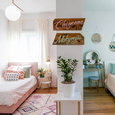 Split Up A dividing wall creates two unique small bedrooms each with a twin bed and a bedside table as featured on Home Network.