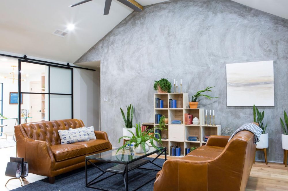 Soft Touch living room with sponged grey focal wall and two tan leather sofas