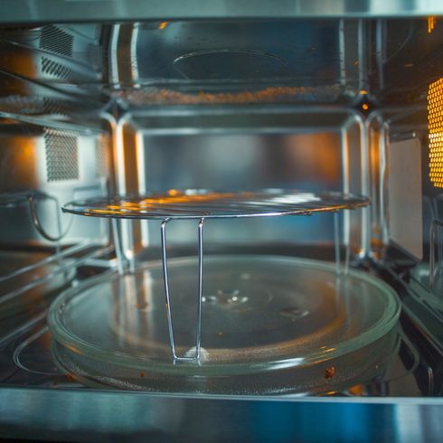 Hand-Wash The Rotating Plate An interior of a clean microwave