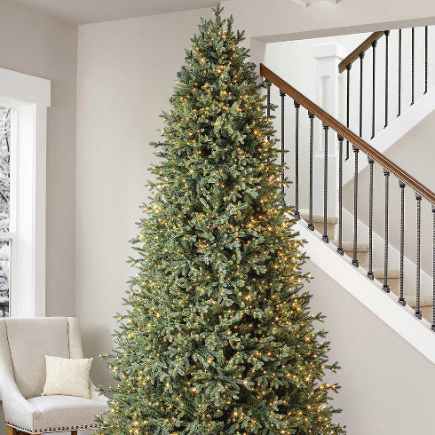 A Tall Beauty A 9-foot tall Christmas tree near a staircase