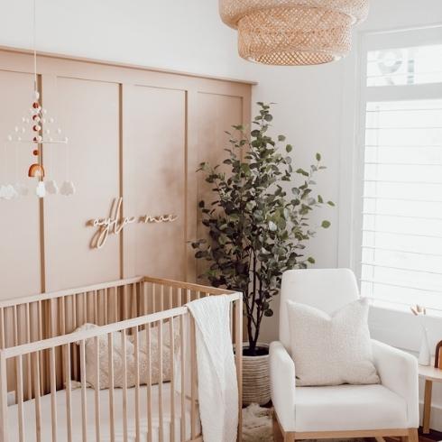 Pale Perfection Neutral nursery with wood-panelled closet