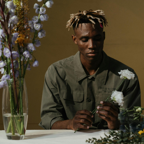 Remove Wilting Flowers A man arranging a bouquet of fresh flowers