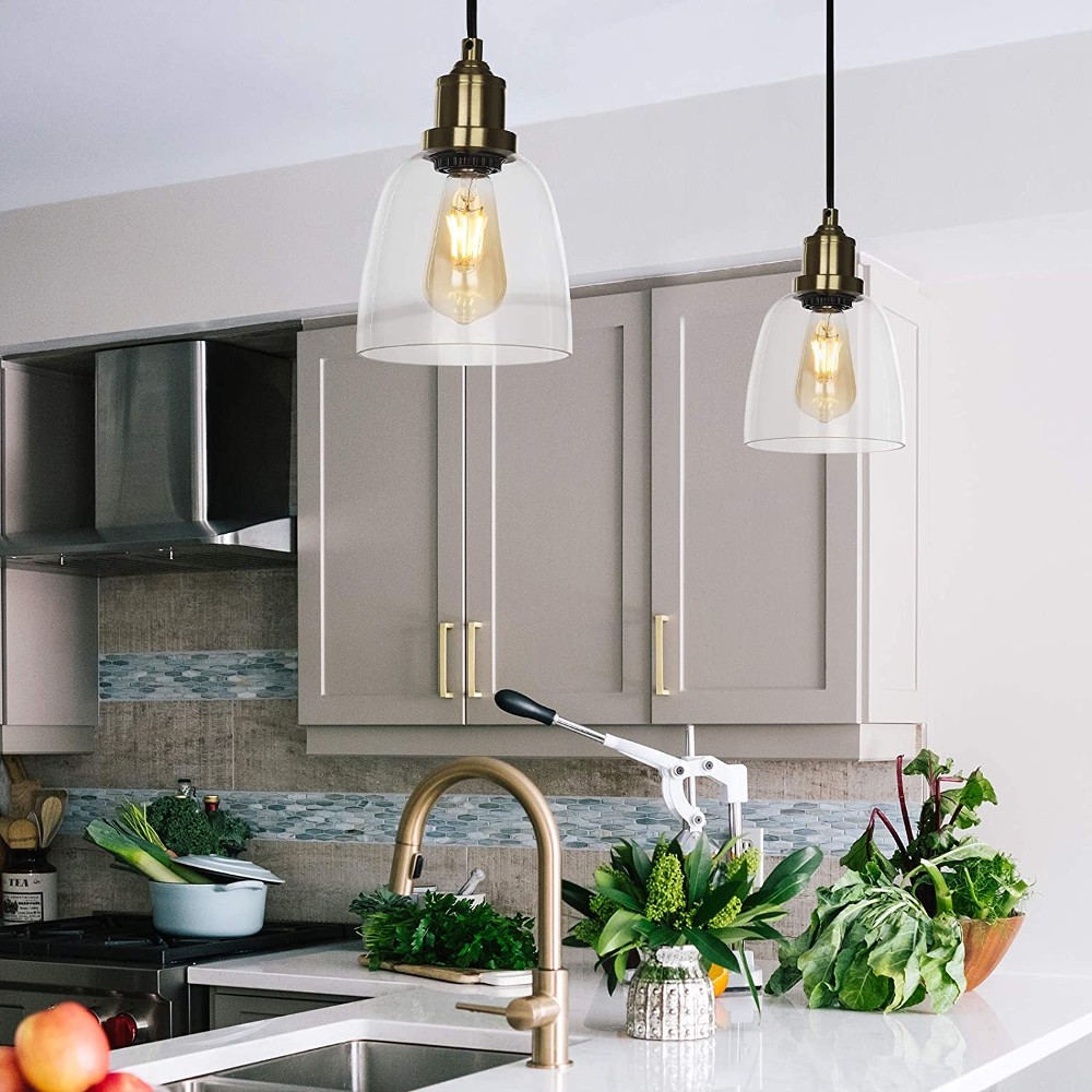Glass Pendants with Edison Bulbs Glass pendant lights over a kitchen counter