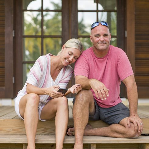 Let’s Talk Books Sarah and Bryan Baeumler on the steps of their Bahamian resort