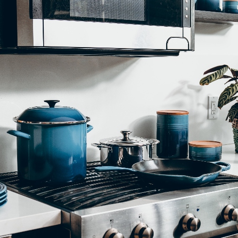 Cookware Assorted blue enamel cookware on the top of a stainless steel stove