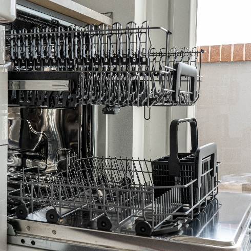 Dishwashers An open dishwasher with the trays pulled out