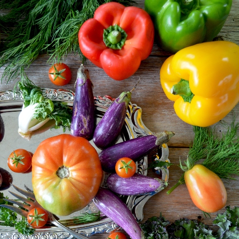 Fresh Produce An assortment of bell peppers, eggplants, tomatoes and other vegetables