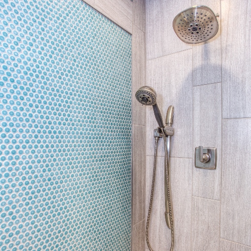 Showers and Bathtubs A shower with light blue tile and rain shower head