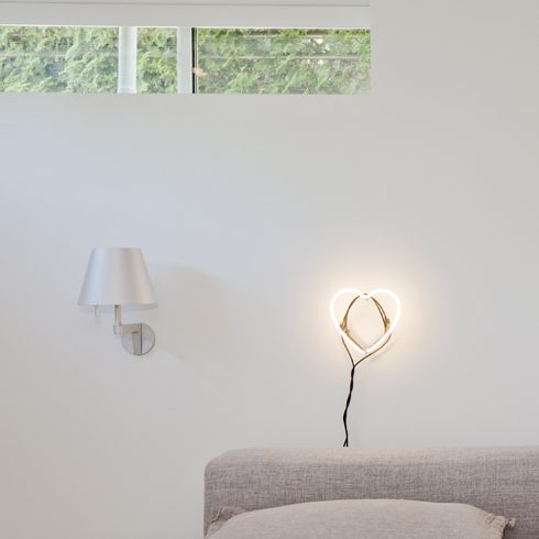 Trim Your Greenery A basement bedroom with narrow windows that overlook the backyard
