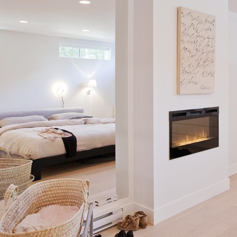 White Walls An open-concept basement apartment featuring a built-in fireplace and bright white walls