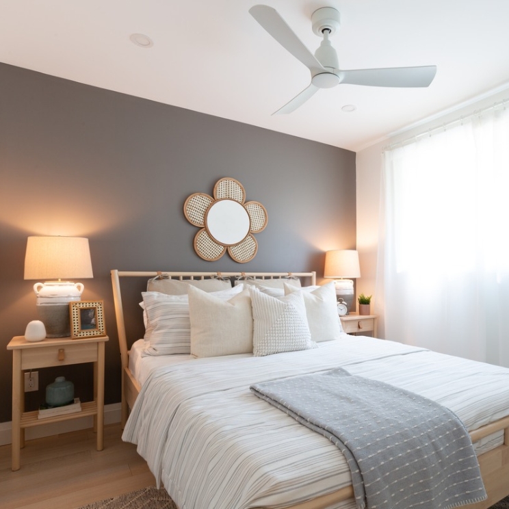 A Space to Unwind Bedroom with grey painted wall and daisy mirror