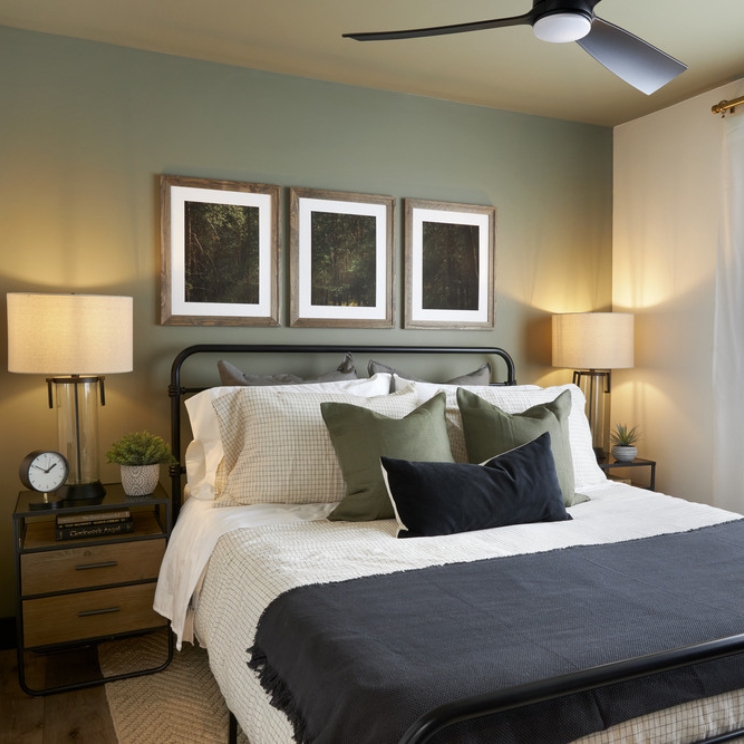 Beauty in Balance Bedroom with green wall and three photos over be