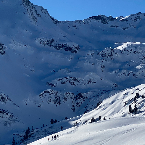 Arlberg, Austria Skiiers on a mountain run at Arlberg Ski Resort in Austria.