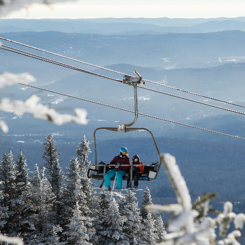 Mont Tremblant, QC Skiiers on a ski lift at Mont Tremblant Ski Resort in Quebec.