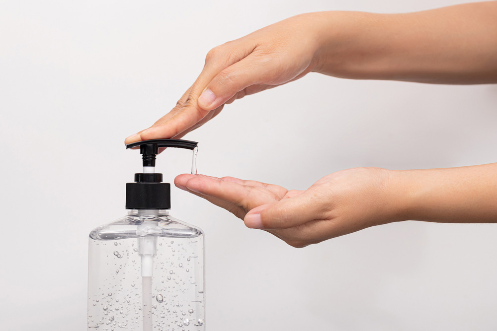 Bleach and Rubbing Alcohol Person using hand cleaner