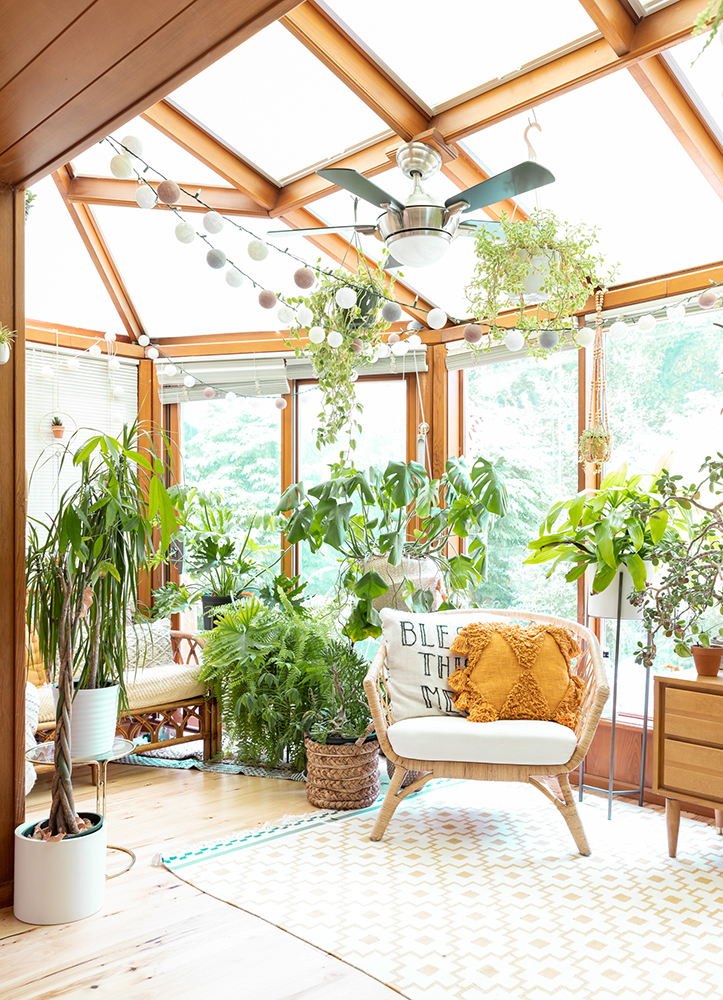 Create a Plant Room Boho sunroom filled with rattan furniture, geometric rug and lots of plants.