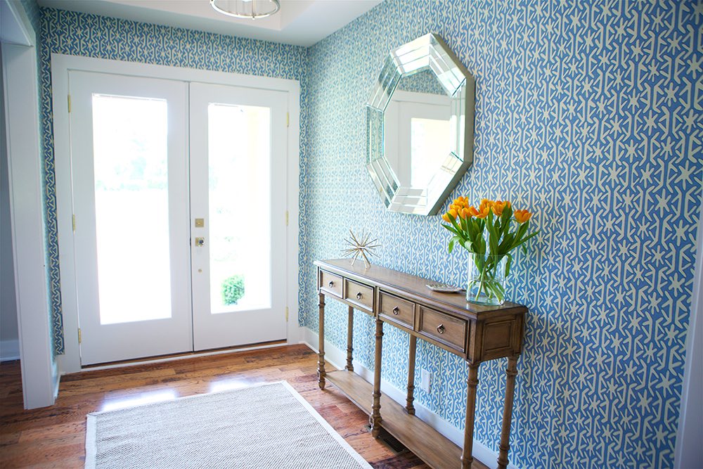 Do Make a Statement front entryway with wallpaper and a wooden console