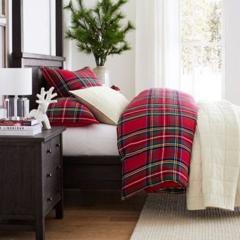 Rad in Plaid Tartan bedsheets in a bedroom