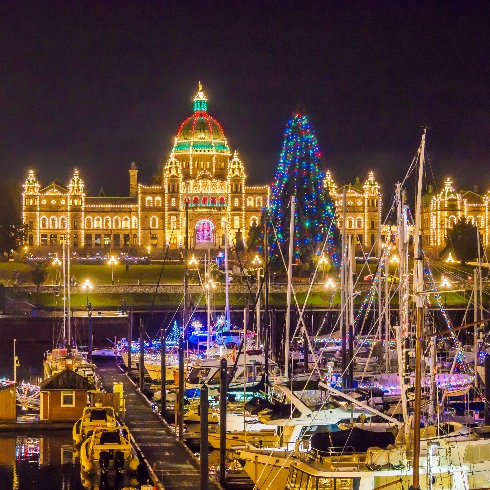 Victoria, British Columbia Victoria, British Columbia during the Christmas season with the buildings and boats decorated with colourful lights.