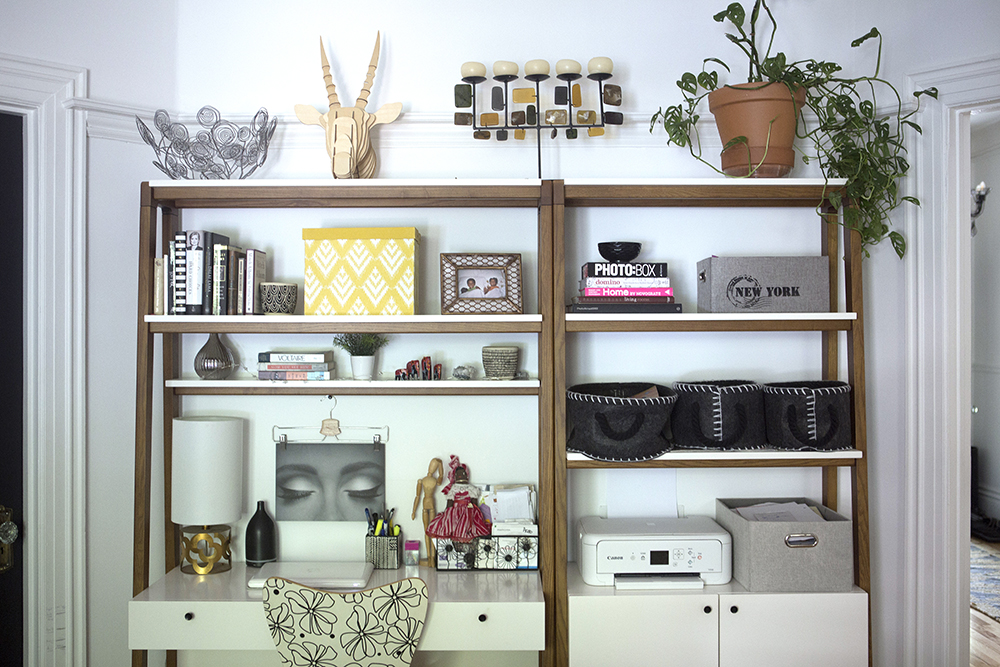 Pack in the Personal Touches white home office space with decor and books on shelves above desk