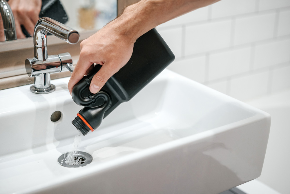 Different Types of Drain Cleaners person pouring drain cleaner into drain