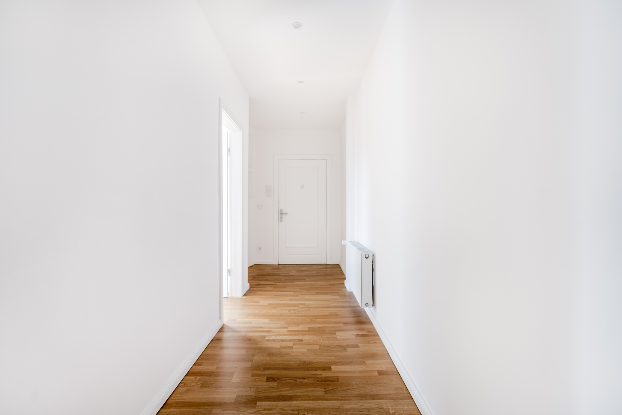 Don’t Forget to Decorate empty hallway with bare white walls