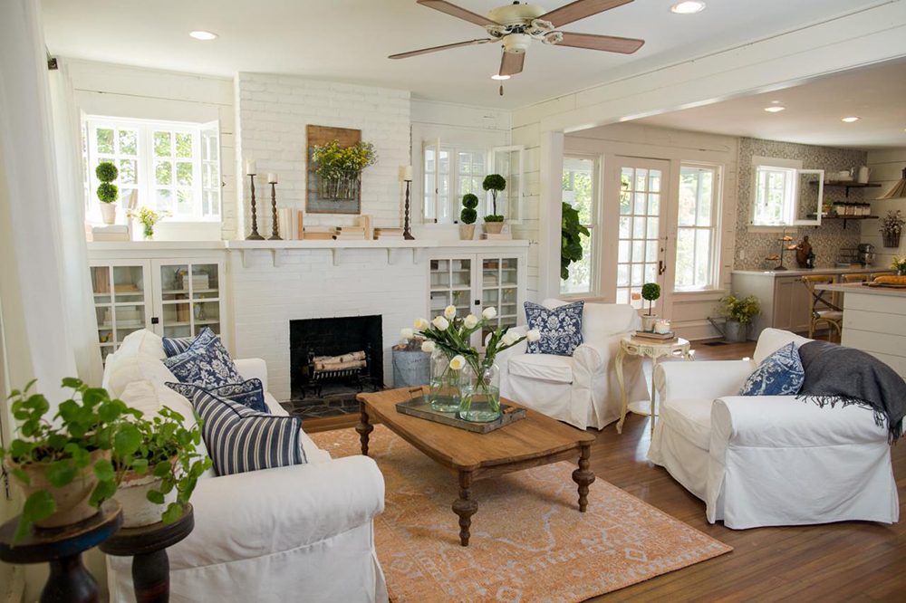 Brighten With Birch Logs Bright and airy living room with white fireplace and white furniture. Inside the fireplace is a stack of white birch logs.
