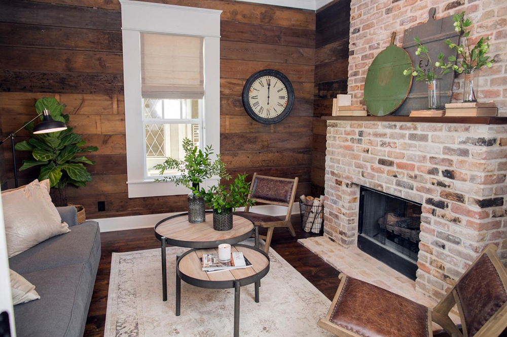 Stack up Firewood Warm, rustic living room with shiplap walls and brick fireplace stacked with firewood.