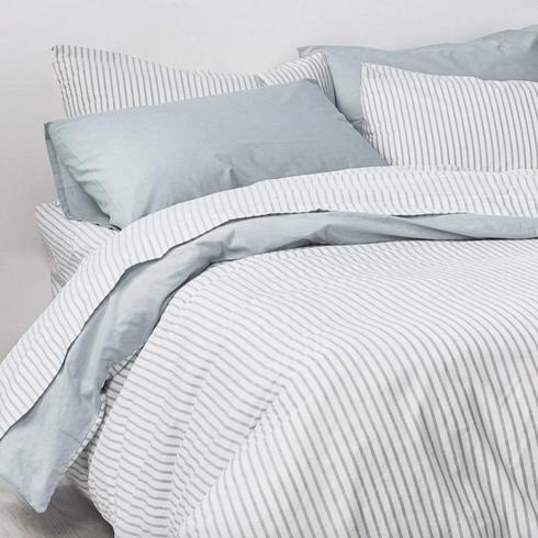 Envello Blue and white sheets in a white bed.