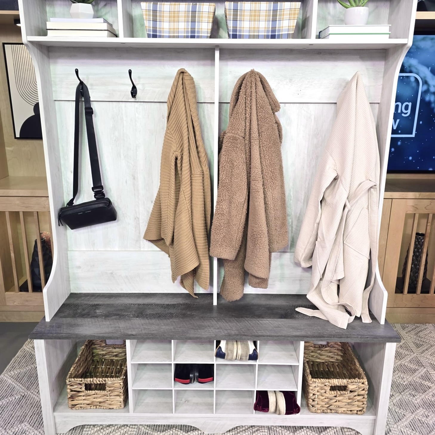 Stylish Shoe Storage Coats and a purse hang from hooks, while shoes sit in organization slots, on a hall storage unit and bench.