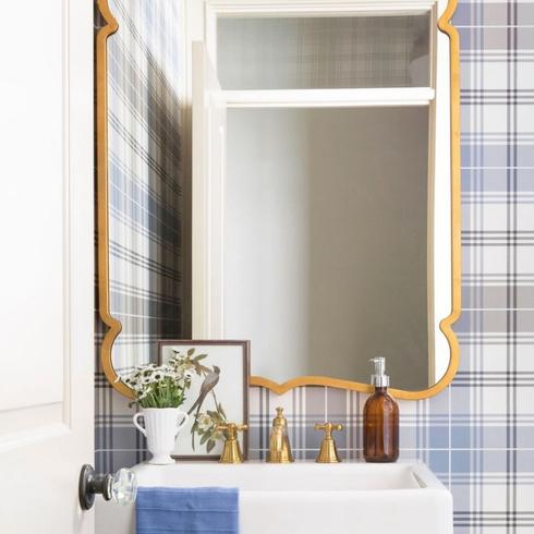 Extra Bathrooms Are Always a Bonus Powder room bathroom with blue plaid wallpaper and ornate gold mirror