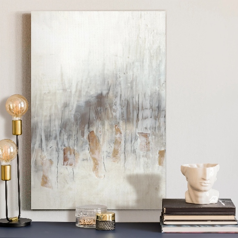 Abstract Artwork An abstract art piece in greys, beiges and blues on a side table topped with books and other decor