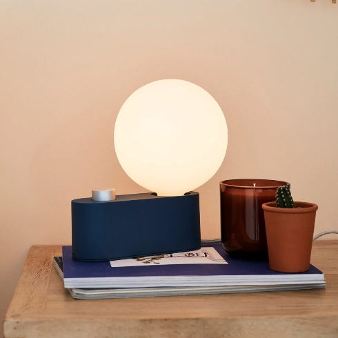 Statement Lamps A blue aluminum table lamp with a globe-style bulb