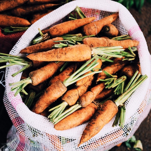 Carrots and Chives Bag a fresh carrots covered in dirt from the garden.