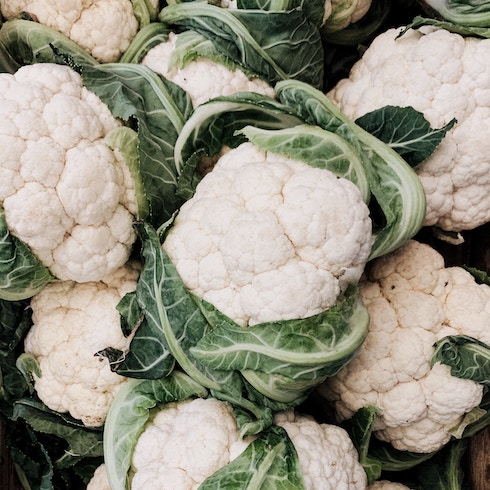 Cauliflower and Sage Heads of cauliflower grouped together in pile.